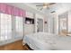 Bedroom featuring tray ceilings, patio access, and easy access to the ensuite bath at 29408 Princeville Dr, San Antonio, FL 33576