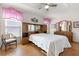 Bright bedroom with a ceiling fan, wood floors, and an abundance of closet and dresser storage at 29408 Princeville Dr, San Antonio, FL 33576