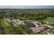 Community clubhouse aerial view showcases amenities like pools, tennis courts, and parking at 29408 Princeville Dr, San Antonio, FL 33576