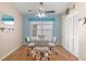 Cozy dining room with a glass table, neutral decor, and bright natural light from large windows at 29408 Princeville Dr, San Antonio, FL 33576