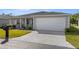 Well-maintained single-story home with a wide driveway, manicured lawn, and a two-car garage at 29408 Princeville Dr, San Antonio, FL 33576