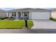 Well-maintained single-story home with a manicured lawn and a two-car garage at 29408 Princeville Dr, San Antonio, FL 33576