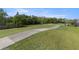 Manicured golf course view features lush green grass and a paved path winding through the landscape at 29408 Princeville Dr, San Antonio, FL 33576