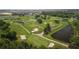 Scenic aerial view of the golf course featuring manicured greens, sand traps, and water hazards at 29408 Princeville Dr, San Antonio, FL 33576