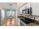 Modern kitchen with stainless steel appliances, granite countertops, and a view to the dining area at 29408 Princeville Dr, San Antonio, FL 33576