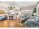Open concept living area with hardwood floors, comfortable furniture, and seamless flow at 29408 Princeville Dr, San Antonio, FL 33576