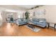 Open living room features two plush couches, hardwood floors, and vaulted ceilings for a modern feel at 29408 Princeville Dr, San Antonio, FL 33576