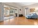Bright sun room with sliding glass doors and hardwood floors opens to a cozy living area at 29408 Princeville Dr, San Antonio, FL 33576