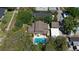 Aerial view showcases a home with a refreshing private backyard swimming pool and lush, mature landscaping at 307 Bay St, Tarpon Springs, FL 34689