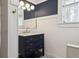 Modern bathroom vanity with dark blue base, marble top and patterned floors at 307 Bay St, Tarpon Springs, FL 34689