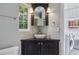 Modern bathroom features a unique corner sink and a window view to the outdoors at 307 Bay St, Tarpon Springs, FL 34689