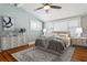 Comfortable bedroom with sloped ceilings, neutral decor, and hardwood floors at 307 Bay St, Tarpon Springs, FL 34689
