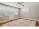 Bedroom with hardwood flooring, area rug, ceiling fan, and natural light at 307 Bay St, Tarpon Springs, FL 34689