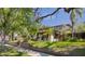 A charming home showcases lush landscaping, a well-maintained lawn, and a welcoming facade at 307 Bay St, Tarpon Springs, FL 34689