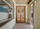 Charming front porch featuring double glass doors, a textured facade, and tiled flooring at 307 Bay St, Tarpon Springs, FL 34689