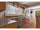 Sunlit kitchen boasts granite countertops, stainless dishwasher and custom cabinets at 307 Bay St, Tarpon Springs, FL 34689