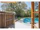 Outdoor pool area with lush greenery and a wooden fence at 307 Bay St, Tarpon Springs, FL 34689