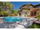 Backyard pool with poolside loungers and a landscaped yard at 307 Bay St, Tarpon Springs, FL 34689
