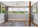 Bright sunroom with hardwood floors, a ceiling fan, neutral walls and an exterior view at 307 Bay St, Tarpon Springs, FL 34689