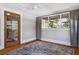 This sunroom has a ceiling fan, hardwood floors, and large windows for natural light at 307 Bay St, Tarpon Springs, FL 34689