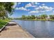 Scenic waterfront view with concrete path, showcasing serene water views and lush greenery along the shoreline at 307 Bay St, Tarpon Springs, FL 34689