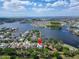 Aerial view showcasing a waterfront community with houses nestled around a tranquil lake at 308 Manns Harbor Dr, Apollo Beach, FL 33572