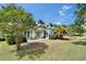 Backyard with a patio, well-manicured lawn, and lush landscaping create a serene outdoor oasis at 308 Manns Harbor Dr, Apollo Beach, FL 33572