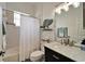 Well-maintained bathroom with a shower-tub combo, decorative mirror, and neutral decor at 308 Manns Harbor Dr, Apollo Beach, FL 33572
