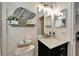 Stylish bathroom featuring a marble vanity, decorative seashell, and updated lighting at 308 Manns Harbor Dr, Apollo Beach, FL 33572