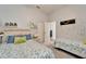 Charming ' bedroom with two twin beds, a polka dot wall and neutral colors at 308 Manns Harbor Dr, Apollo Beach, FL 33572