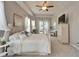 Bedroom with tray ceiling, tv, and white wrought iron bed at 308 Manns Harbor Dr, Apollo Beach, FL 33572