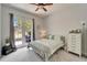 Cozy bedroom featuring a queen-sized bed, a chest of drawers, and access to the backyard at 308 Manns Harbor Dr, Apollo Beach, FL 33572