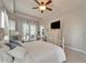 Cozy bedroom featuring a white wrought iron bed and tray ceiling at 308 Manns Harbor Dr, Apollo Beach, FL 33572