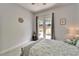 Calm bedroom with a queen-sized bed, neutral decor, and direct access to the backyard at 308 Manns Harbor Dr, Apollo Beach, FL 33572