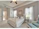 Comfortable bedroom with tray ceiling, wrought iron bed and serene decor at 308 Manns Harbor Dr, Apollo Beach, FL 33572