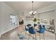 Stylish dining room with an elegant chandelier, decorative wall art, and seating for four at 308 Manns Harbor Dr, Apollo Beach, FL 33572