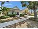 Charming single-Gathering home featuring a covered front porch and neatly landscaped yard at 308 Manns Harbor Dr, Apollo Beach, FL 33572