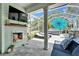 Inviting screened-in patio with a fireplace, TV, lounge seating, and a hot tub at 308 Manns Harbor Dr, Apollo Beach, FL 33572