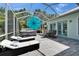 Relaxing screened patio with hot tub, lounge chairs, and dining table for enjoying the Florida sunshine at 308 Manns Harbor Dr, Apollo Beach, FL 33572