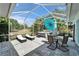 Stunning screened-in patio with a hot tub, lounge chairs, and outdoor dining space at 308 Manns Harbor Dr, Apollo Beach, FL 33572