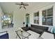Inviting outdoor seating area with ceiling fan and view from the front door at 308 Manns Harbor Dr, Apollo Beach, FL 33572