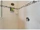 A tile shower with pebble accents and shower caddy offers both style and convenience at 308 Manns Harbor Dr, Apollo Beach, FL 33572