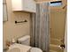Clean bathroom featuring a shower-tub combination with a patterned curtain and functional fixtures at 3114 Briar St. St, Wesley Chapel, FL 33543