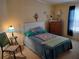 A cozy bedroom featuring a queen bed, soft carpeting, and charming decor for a comfortable retreat at 3114 Briar St. St, Wesley Chapel, FL 33543