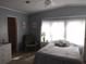 A serene bedroom with a ceiling fan, complemented by soft blue walls and a comfortable rocking chair at 3114 Briar St. St, Wesley Chapel, FL 33543