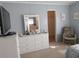 Bedroom featuring a large closet, a mirrored dresser, and a rocking chair, providing comfort and storage at 3114 Briar St. St, Wesley Chapel, FL 33543