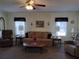 Warm living room with plush seating, a ceiling fan, and bright windows, creating an inviting space at 3114 Briar St. St, Wesley Chapel, FL 33543