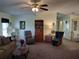 Inviting living room featuring plush seating, a ceiling fan, and a comfortable atmosphere for relaxation and entertainment at 3114 Briar St. St, Wesley Chapel, FL 33543