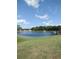 Beautiful community pond with fountain, dock, and bright green grass surrounding at 3114 Briar St. St, Wesley Chapel, FL 33543
