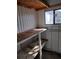 View of the interior of the shed with shelving and a window at 3114 Briar St. St, Wesley Chapel, FL 33543